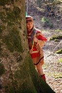 girl in indian costume near the tree