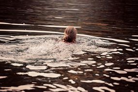 a woman who is floating on the lake