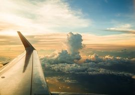 wing of the plane in the clouds