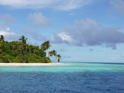 light clouds over an island in the ocean