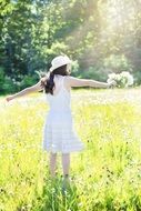 happy pretty girl in wildflowers meadow