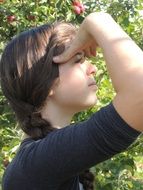 girl looks into the distance in the garden