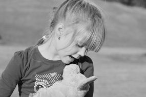 child girl blond teddy bear black and white photo