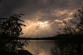 Beautiful Mondsee lake among the plants in Austria under beautiful and colorful sunset