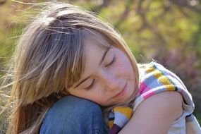 blonde girl with closed eyes relaxed