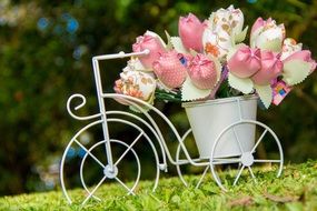 artificial tulips on a decorative stand