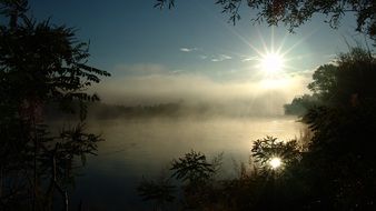 landscape of sunrise above foggy river