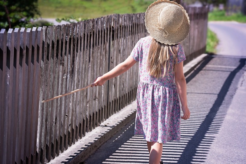Blonde girls in hat with stick