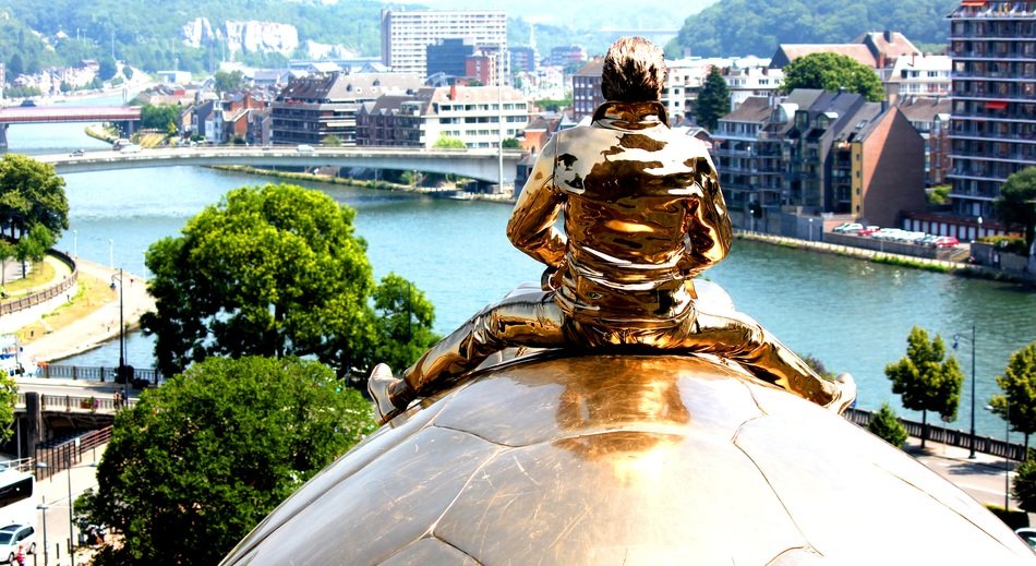 Golden sculpture of a turtle on the background of the river