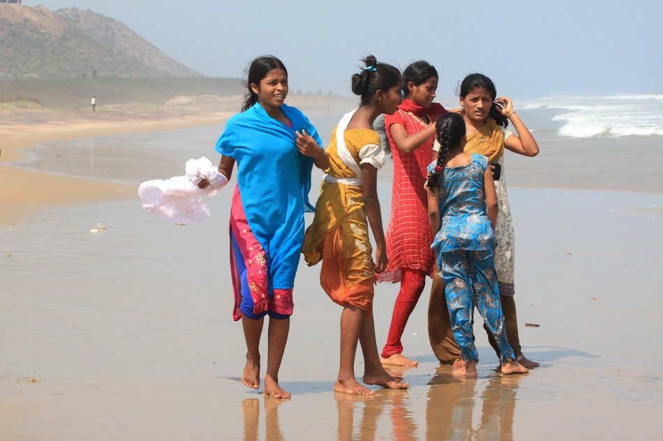 indian girls walking on the beach