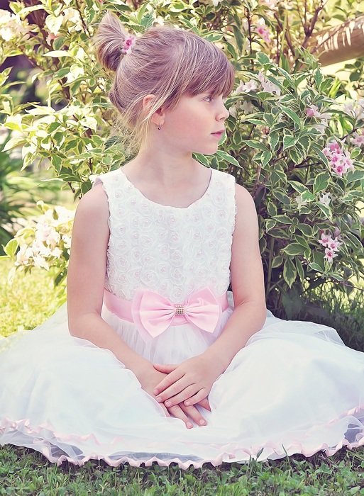 girl in nice dresssitting by flowers
