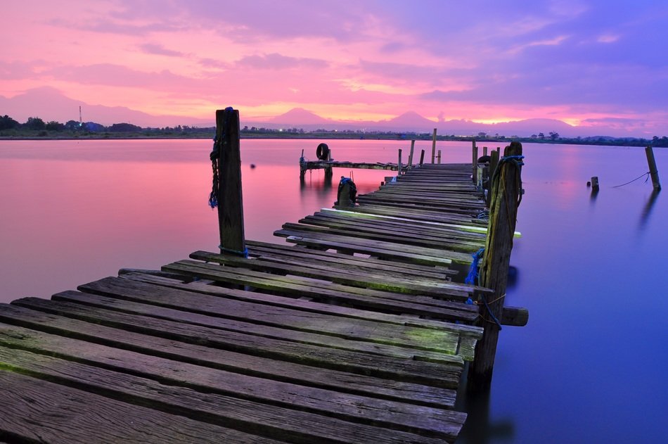 old pier on the background of pink sunset