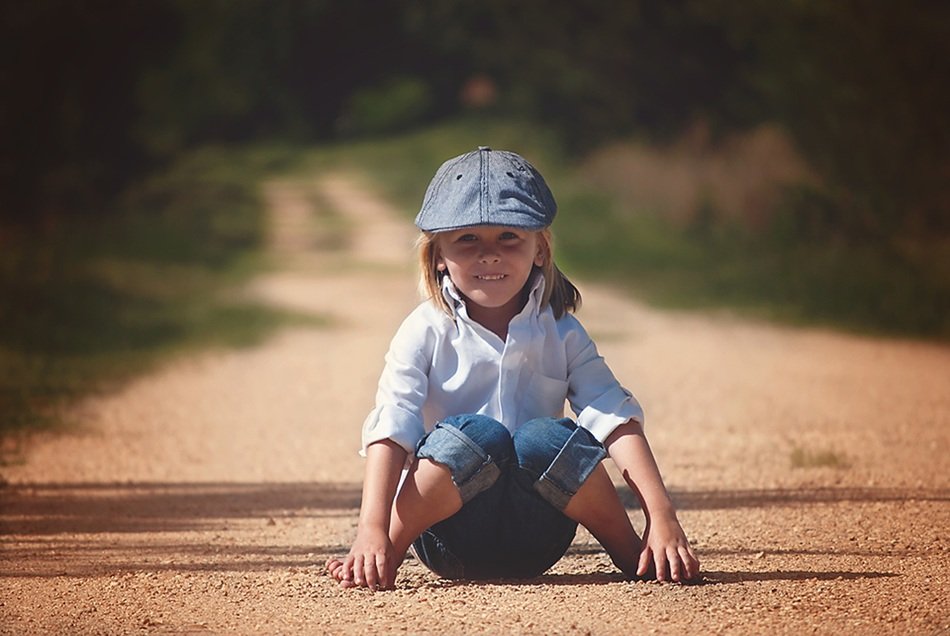 Happy baby sitting on the road