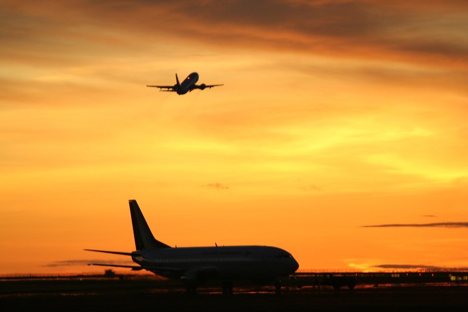 take-off of a plane against a golden sky