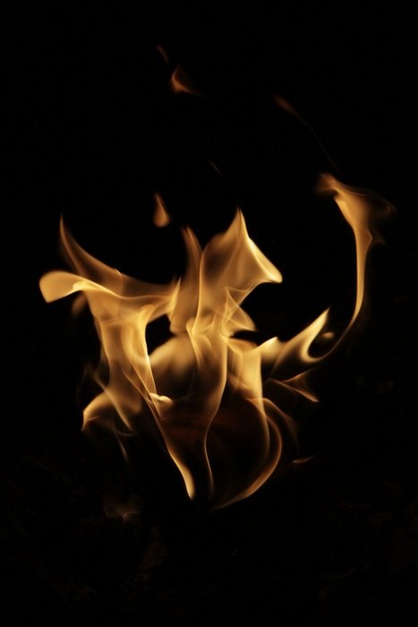 the flames of the fire in the dark