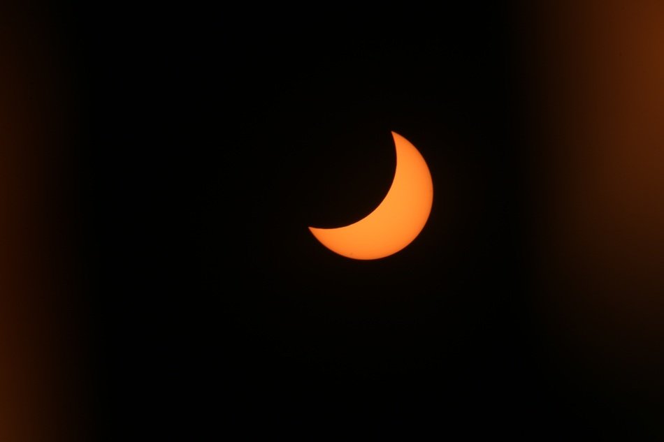 partial solar eclipse in the dark sky