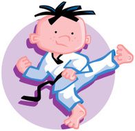 Young boy doing a karate kick