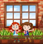 Little girls standing outside house
