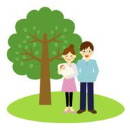 Happy young couple standing near the tree