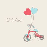 Tricycle and two heart-shaped balloons