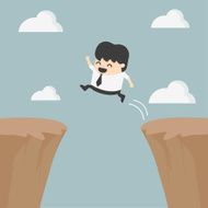 Businessman jumping over the cliff