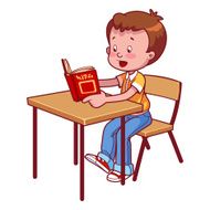 Cute schoolboy behind a school desk reading book