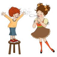 Boy and girl playing with soap bubbles