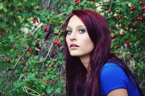 Girl with the colorful hair in the forest