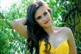 portrait of a model in a yellow dress in nature