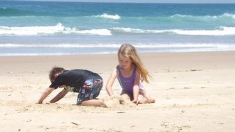 children on a sandy beach on a sunny day