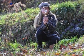 child girl with dandelion in a forest