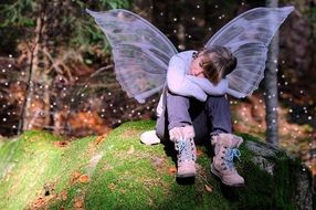 Girl with the wings in the forest