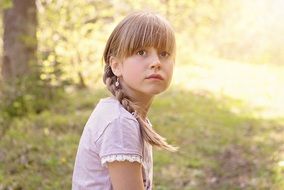 Little girl with a scythe with an expressive look