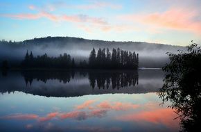 reflection of pink clouds in a lake