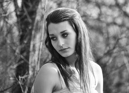 Black and white photo of the girl in the forest