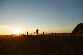 standing silhouette of a person at sunset