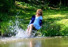 happy nice girl splashing water outdoor