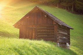log house on a green hill
