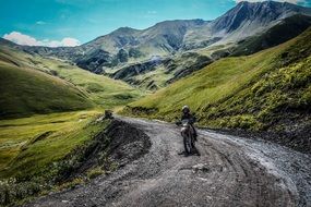 motorcyclist rides on a mountain road