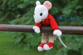 soft mouse hanging on the railing