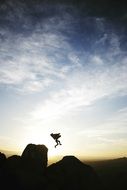 jumping person on the mountain peak