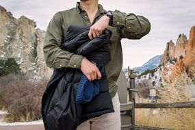 man with jacket in hands