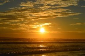 The ocean at sunset against a background of clouds