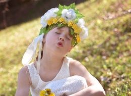 portrait of singing girl with floral wreath