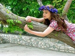 girl in a blue wreath on a tree