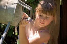 Little girl with watering