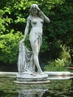 statue of a beautiful woman on the lake