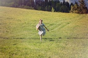 little girl running on green grass