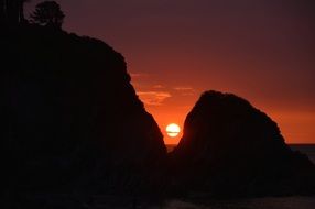 red sun between rocks