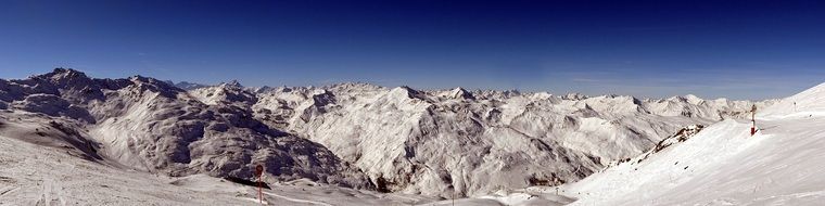 panoramic view of the alpine mountains under a clear sky